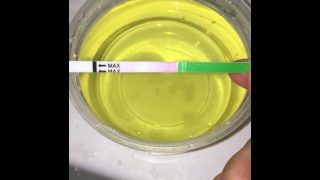 Girl Pissing Into A Container And Plays Urine With Fingers. 3Rd Day Of Ovulation Test