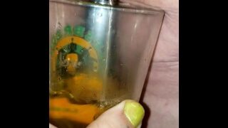 BBW Mistress pisses into glass.  While her pet holds the glass.