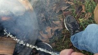 Putting out a fire at the campsite by pissing on it