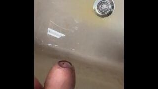 Soft Asian penis peeing in sink