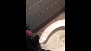 slave peeing in public toilet