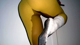 Girl pee desperation in front of closed toilet door and wetting yoga pants