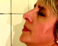 Wild German lady gets pissed and fucked in the bathroom by a long cock