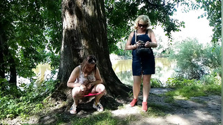 Two girls stopped on the side of the road to pee, attracting the attention of passing cars, golden shower in a public place