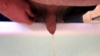 Pissing into a full bath tub